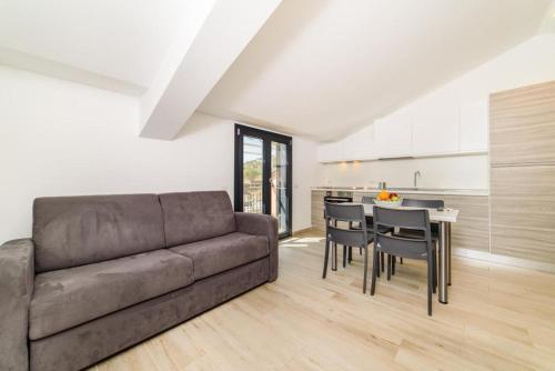 a living room with a couch and a table with chairs at Casa Vacanze Maraldo in Marina di Camerota