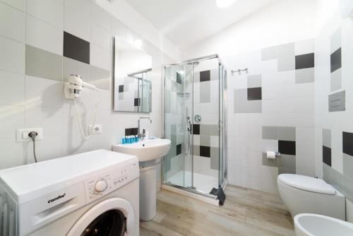 a bathroom with a sink and a washing machine at Casa Vacanze Maraldo in Marina di Camerota