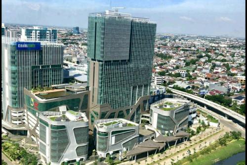 an aerial view of a city with tall buildings at Studio Pleasant Tifolia in Jakarta