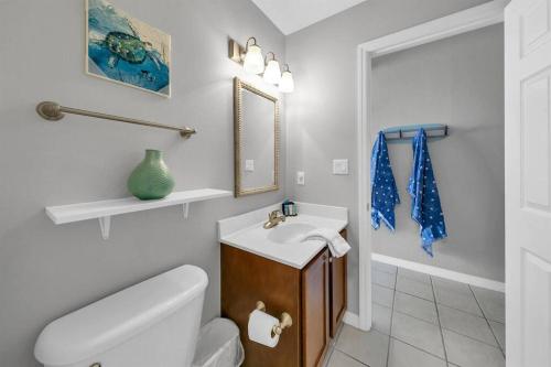 a white bathroom with a sink and a toilet at Gulf Dunes 506 Hello Sunshine in Fort Walton Beach