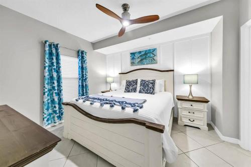 a bedroom with a bed and a ceiling fan at Gulf Dunes 506 Hello Sunshine in Fort Walton Beach