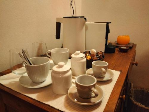 a wooden table with cups and saucers on it at Apartmán Stodola in Malá Morávka