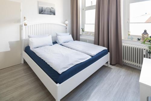 Postel nebo postele na pokoji v ubytování Norderney Sandkorn
