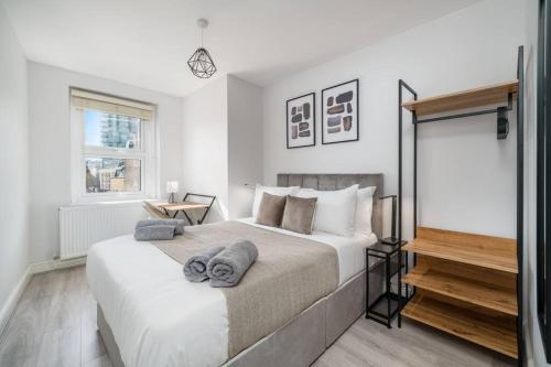 a bedroom with a large bed with towels on it at Trendy 2bed apartment in Brick Lane - 3rd Floor in London