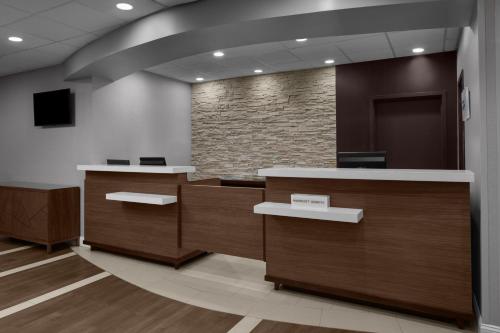 an office lobby with desks and a stone wall at Residence Inn White Plains Westchester County in White Plains