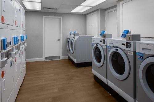 a laundry room with washers and dryers in a store at Residence Inn White Plains Westchester County in White Plains
