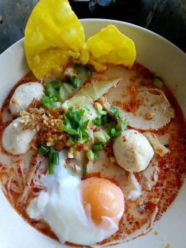 a bowl of food with eggs and vegetables on top at Mountain View Resort and Phupha Srirung Resort in Phuket