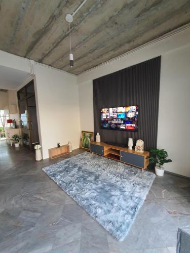 a large living room with a large tv on a wall at 3 BR Cozy Home Skytrain View BKK in Bangkok