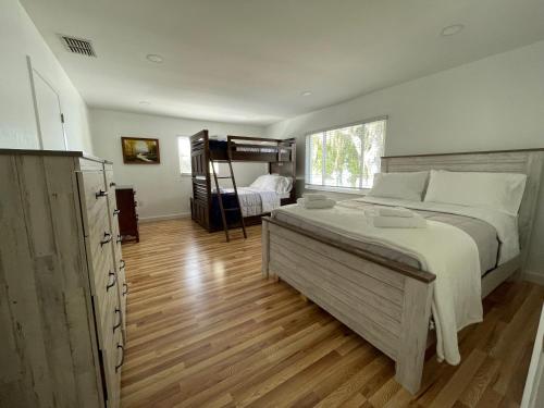 a bedroom with a large bed and a bunk bed at Lake Pearl House in Lake Placid