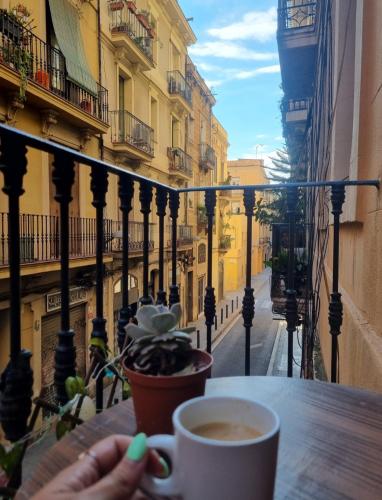 a cup of coffee sitting on a table on a balcony at Dorado 2 in Barcelona