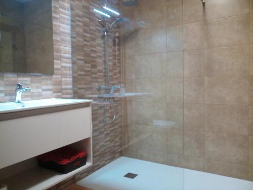 a bathroom with a shower and a sink at Casa Ca lEster Terra alta Matarraña in Caseras