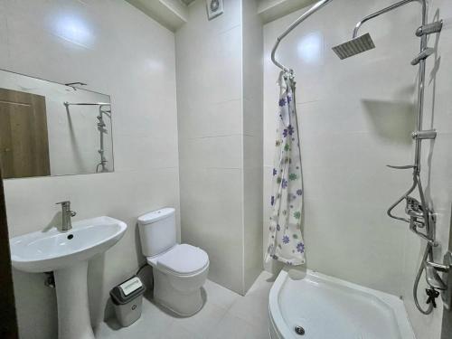 a white bathroom with a sink and a toilet at Heven of Chilovski 2 in Filipów