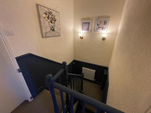an overhead view of a stairway with a blue railing at Contractor & Family House - Central Grantham in Grantham