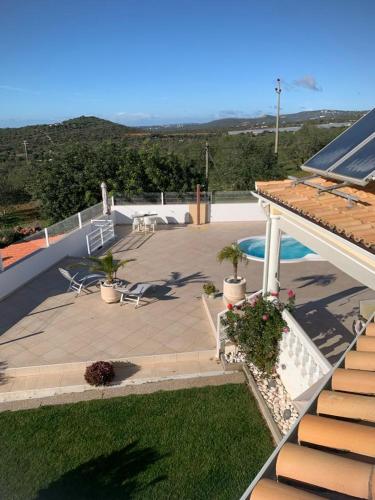 a view of a patio with chairs and avisor at Casa Amar in Loulé
