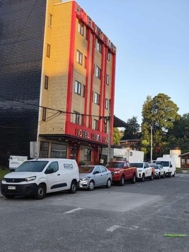 a row of cars parked in front of a hotel at Hotel Vista Mar in Puerto Montt