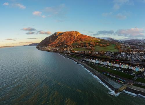 an aerial view of a city and the ocean at Uwch-Y-Mor in Llanfairfechan