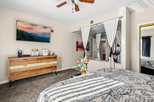 a bedroom with a bed and a ceiling fan at 2 King BRs Balcony Resort Amenities Free Tix in Pigeon Forge