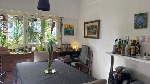 a dining room with a table with a vase on it at Alquiler Temporario Rosario 15 in Rosario