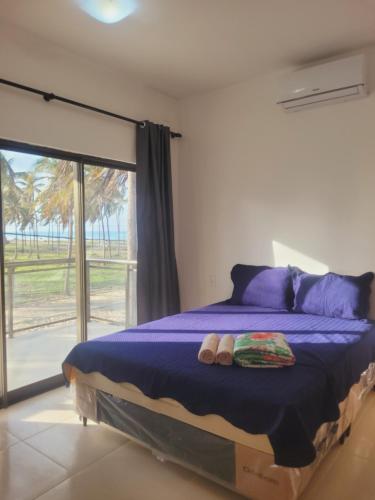 a bedroom with a bed with two slippers on it at FLECHEIRAS ATLANTICO in Trairi