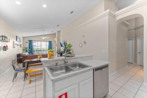 a kitchen with a sink and a dining room at Magical Oasis Retreat in Orlando