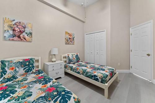 a bedroom with two beds and a night stand at Poolside Orlando Oasis in Orlando