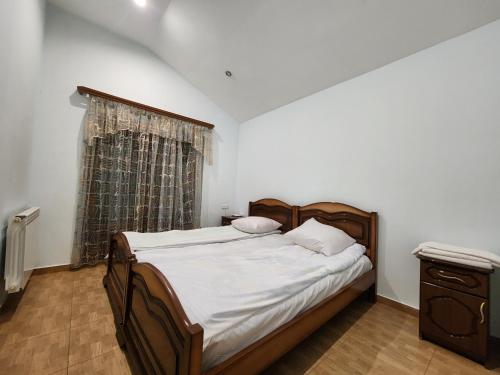 a bedroom with a large bed and a window at King in Tsaghkadzor