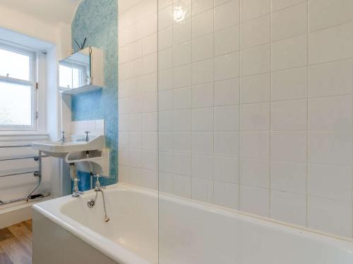 a bathroom with a bath tub and a sink at 2 Bed in Crail CA006 in Crail