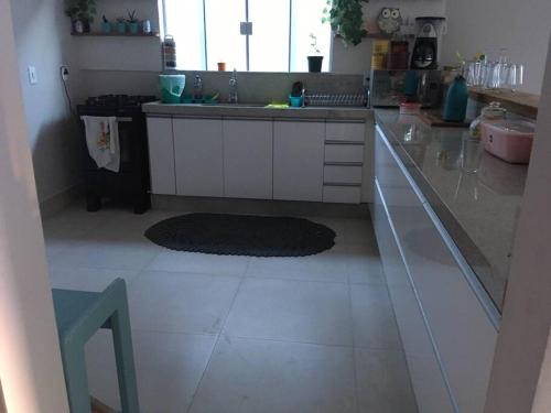 a kitchen with a sink and a counter top at Casa de Praia in Cananéia