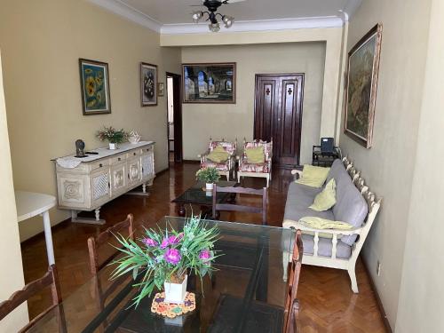 a living room with a couch and a table at São Salvador, Flamengo, 3 quartos in Rio de Janeiro
