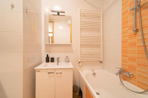 e bagno con vasca, lavandino e vasca. di Trendy apartment 5 min to city centre!` a Zagabria