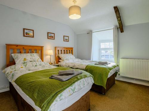 a bedroom with two beds and a window at 2 Bed in Llangynidr BN052 in Llangynidr