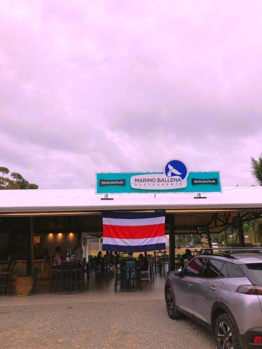 a car parked in front of a restaurant at Club Marino Ballena in Uvita