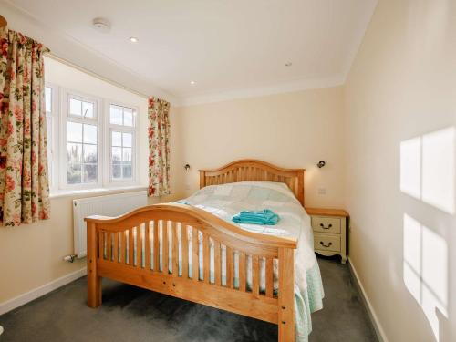 a bedroom with a wooden bed and a window at 2 Bed in Llangollen 43916 in Overton