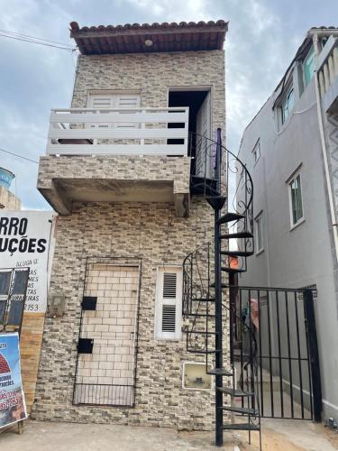 a brick building with a balcony on the side of it at Casa do diego in Aracati