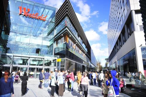 a group of people walking in front of a building at Luxurious En-suite Soft Water Air Conditioning TV RIPPLE in London