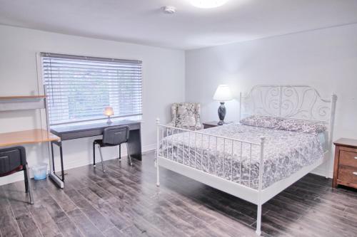 a bedroom with a white bed and a desk and a desk at Large and beautiful master room with private bathroom in Vaughan