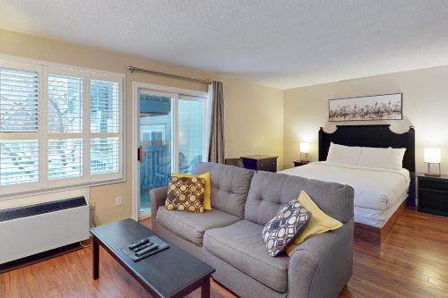 a living room with a bed and a couch and a bed at Condo 704 at North Creek Resort in Blue Mountains