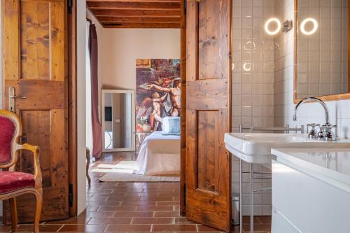 a bathroom with a sink and a painting on the wall at La Celeste Galeria in Mantova