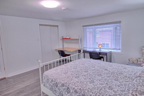 a bedroom with a bed and a desk and a window at Large and beautiful master room with private bathroom in Vaughan