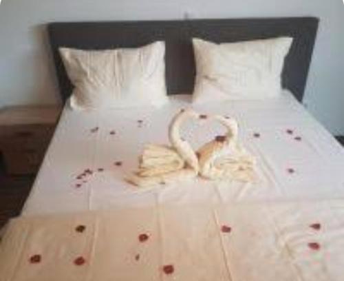 a bed with two swans towels on it at Hotel Zur Bahnhof in Crailsheim