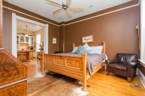 a bedroom with a bed and a chair in it at iKlektik House // Cardinal in Chicago