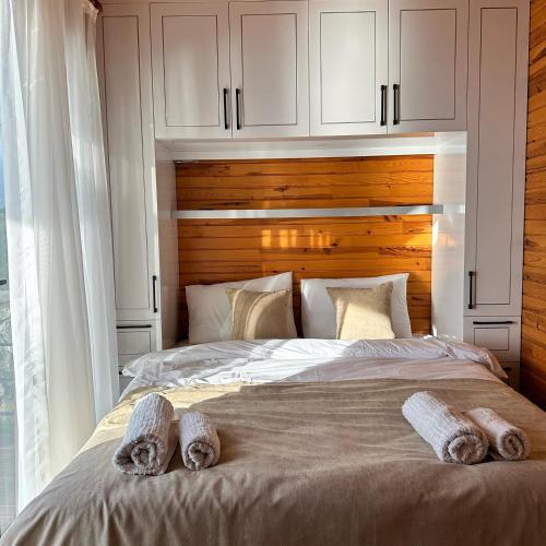 a bedroom with a large bed with a wooden headboard at Mesibu Bungalow 