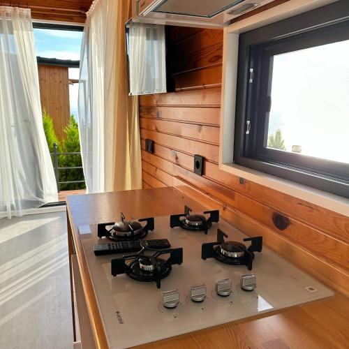 a stove top in a kitchen with a window at Mesibu Bungalow 