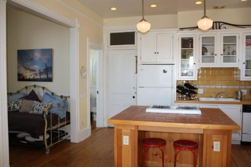 a kitchen with a center island in a room at iKlektik House // Cardinal in Chicago