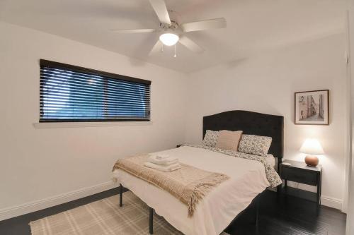 a bedroom with a bed and a ceiling fan at The Charming Home with a Pool in Yuba City