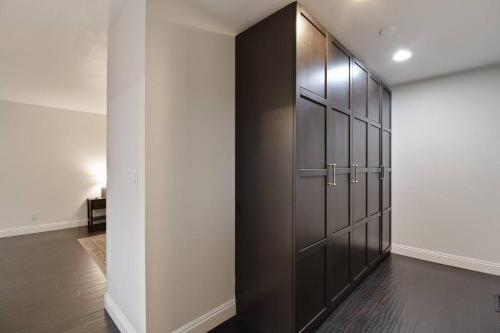 a room with a closet with black cabinets at The Charming Home with a Pool in Yuba City