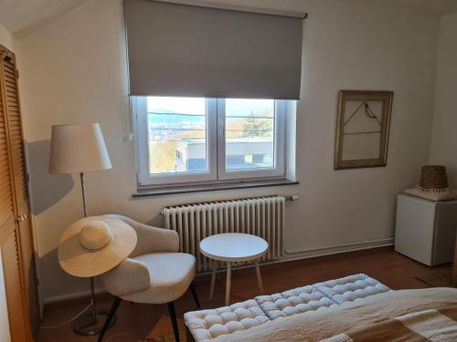 a living room with a bed and a window at Bed vue sur vallée de la Meuse Namur in Bouge