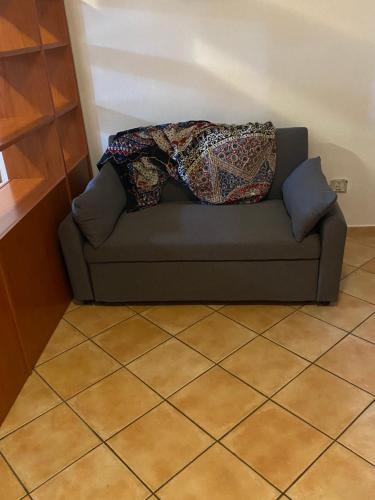 a couch with two pillows on top of it at robbyone 2 in Olbia