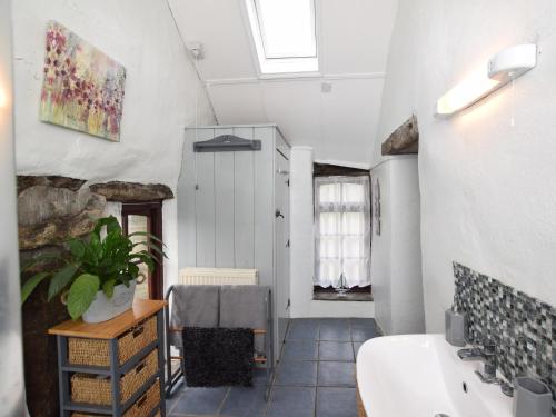 a bathroom with a sink and a bath tub at 2 Bed in Tintagel 51184 in Lanteglos