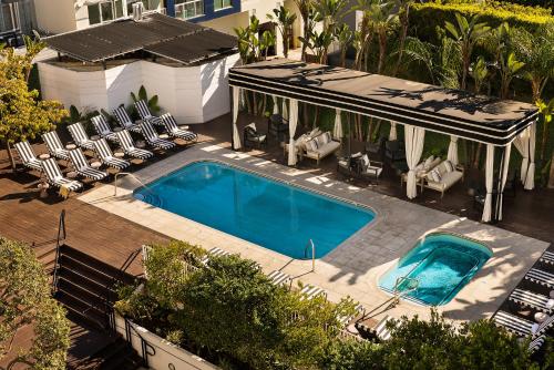 an overhead view of a swimming pool with chairs and a house at Sonder The Beacon in Los Angeles